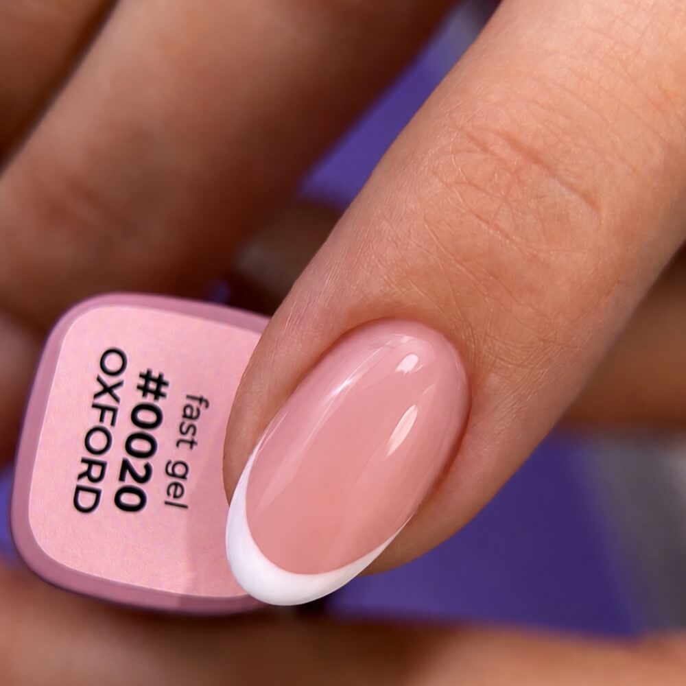 12ml — DNKa Fast Gel #0020 Oxford — swatch on nail tip, coral pink finish