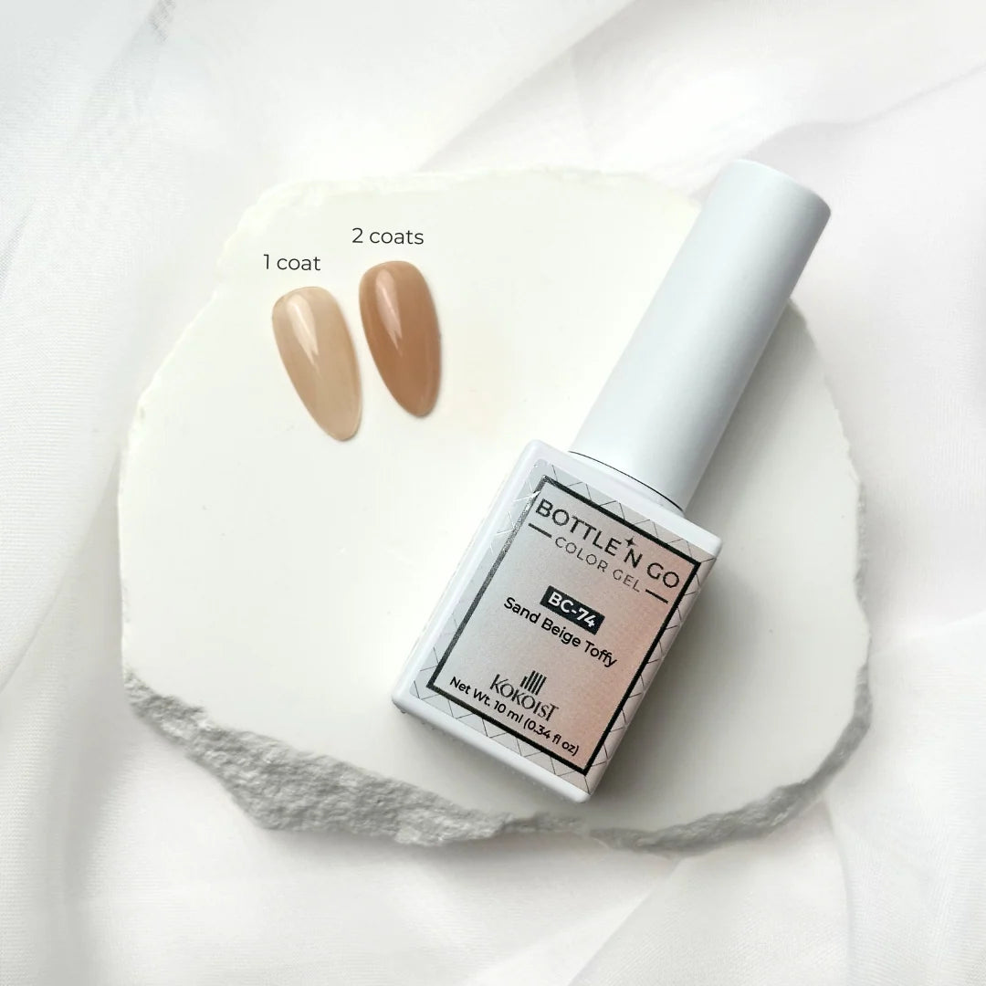 10ml — Kokoist Bottle 'N Go BC-74 Sand Beige Toffy — swatch on nail tip, translucent deep beige finish