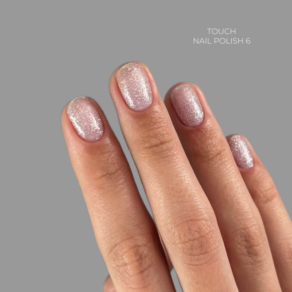 TOUCH Nail Polish 06 — swatch on nail tip, sheer silver shimmer finish