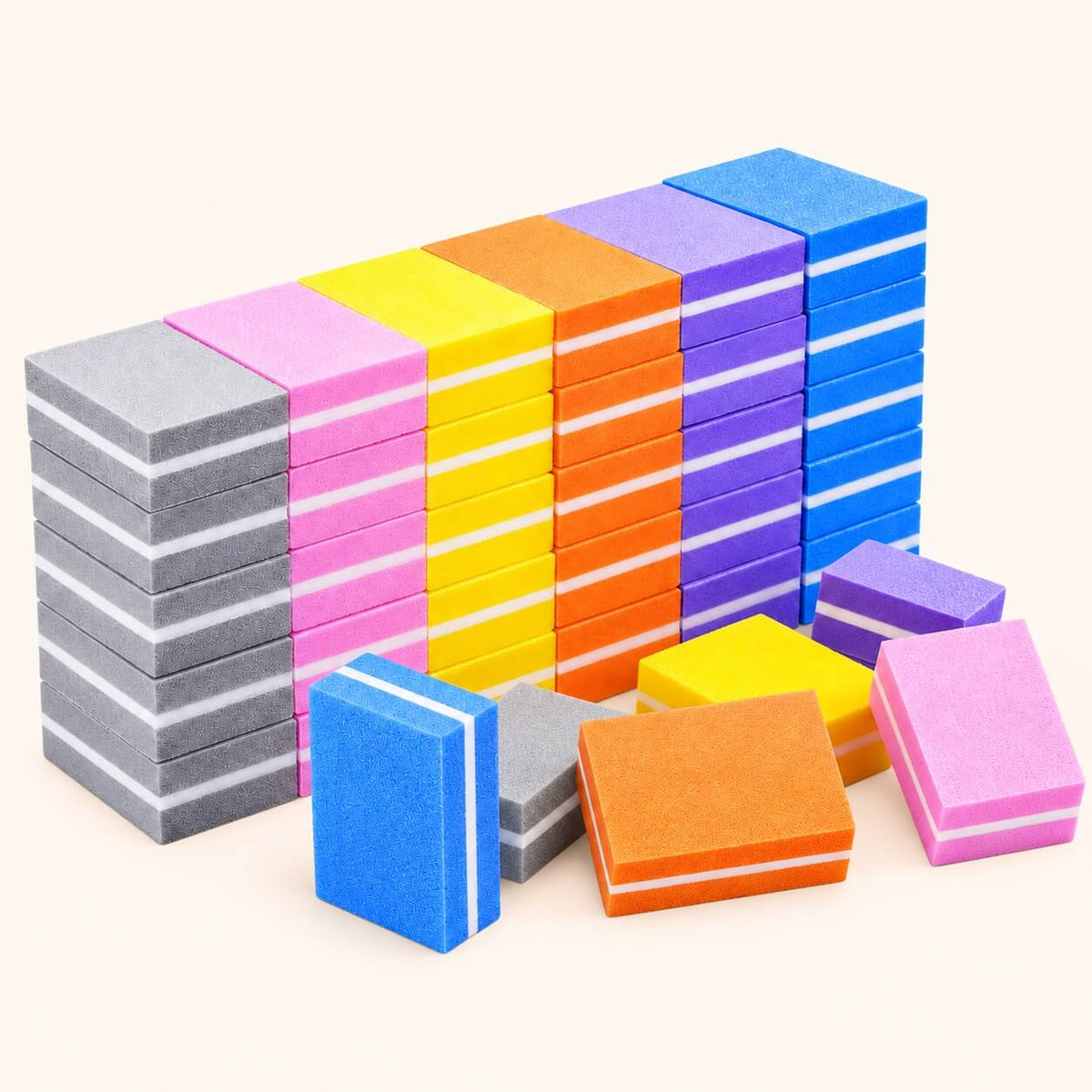 Stacks of colorful disposable nail buffers with a white middle layer