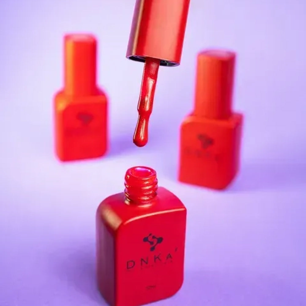 Nail technician applying DNKa Cover Base #0002 Gambling to a natural nail