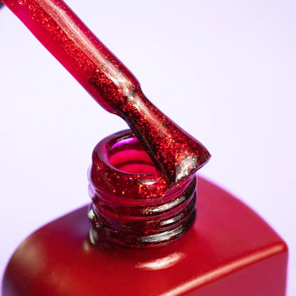 Close-up swatch showing the fuchsia-red glitter finish of DNKa Cover Base #0005 Daring