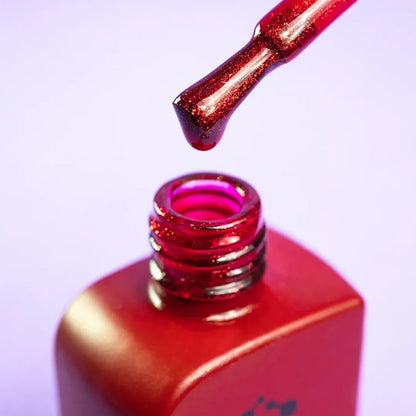 Nail technician applying DNKa Cover Base #0005 Daring to a natural nail