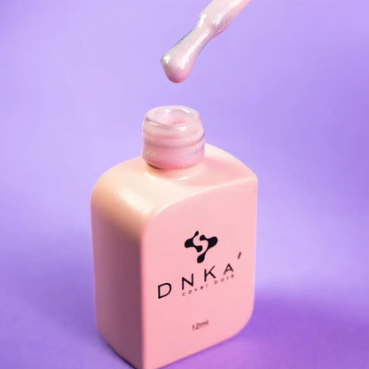 Nail technician applying DNKa Cover Base #0009 Nice to a natural nail