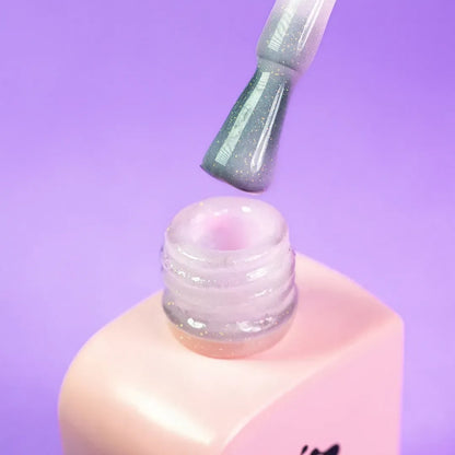 Nail technician applying DNKa Cover Base #0010 Wonderful to a natural nail