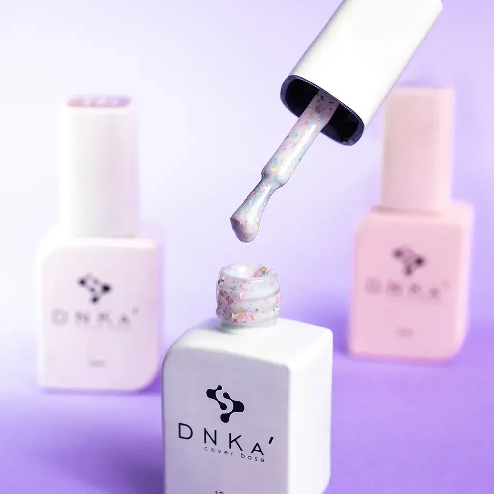 Nail technician applying DNKa Cover Base #0011A Happy to a natural nail