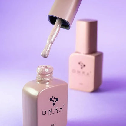 Nail technician applying DNKa Cover Base #0012 Shining to a natural nail