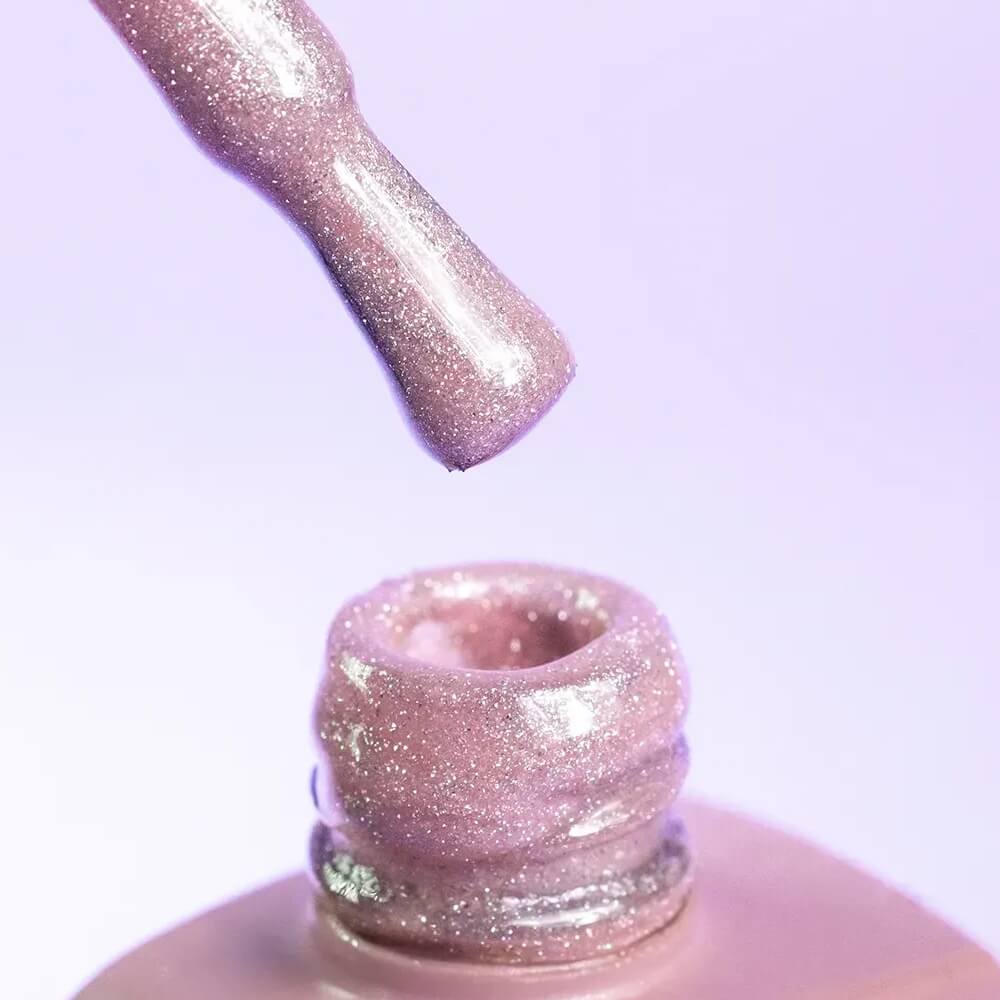 Top view of the DNKa Cover Base #0012 Shining bottle and brush