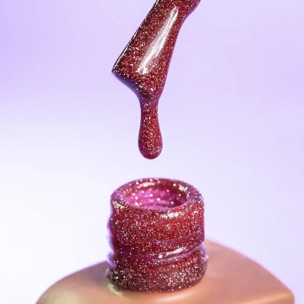 Nail technician applying DNKa Cover Base #0012A Confident to a natural nail