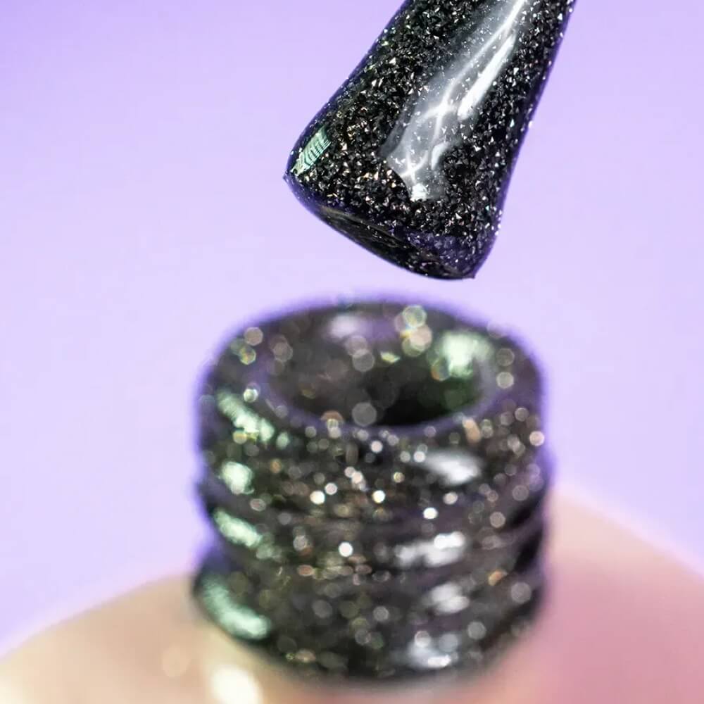 Close-up swatch showing the reflective gray finish of DNKa Cover Base #0013A Cheerful