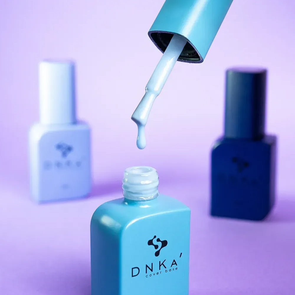 Nail technician applying DNKa Cover Base #0016 Sincere to a prepped nail plate