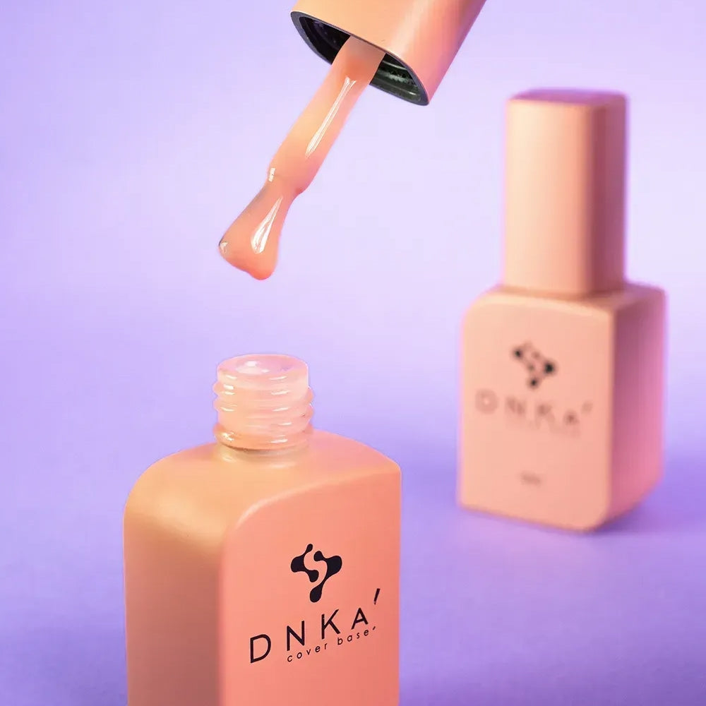 Nail technician applying DNKa Cover Base #0017 Kind to a prepped nail plate