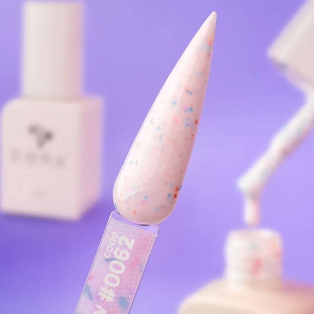 Freshly cured nails coated in 12ml Mellow, showing the milky pink base and matte glitter texture