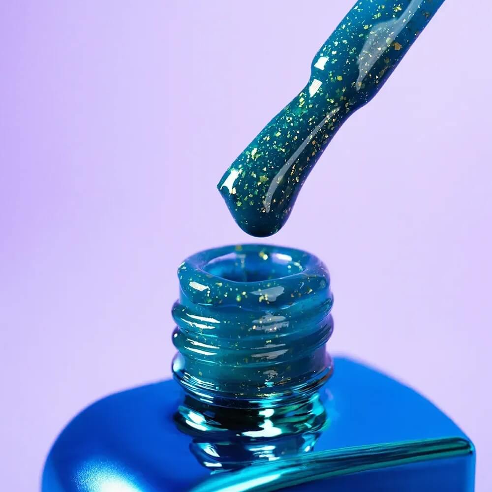 Freshly cured nails coated in 12ml Aquamarine, showing the blue-green base and gold shimmer