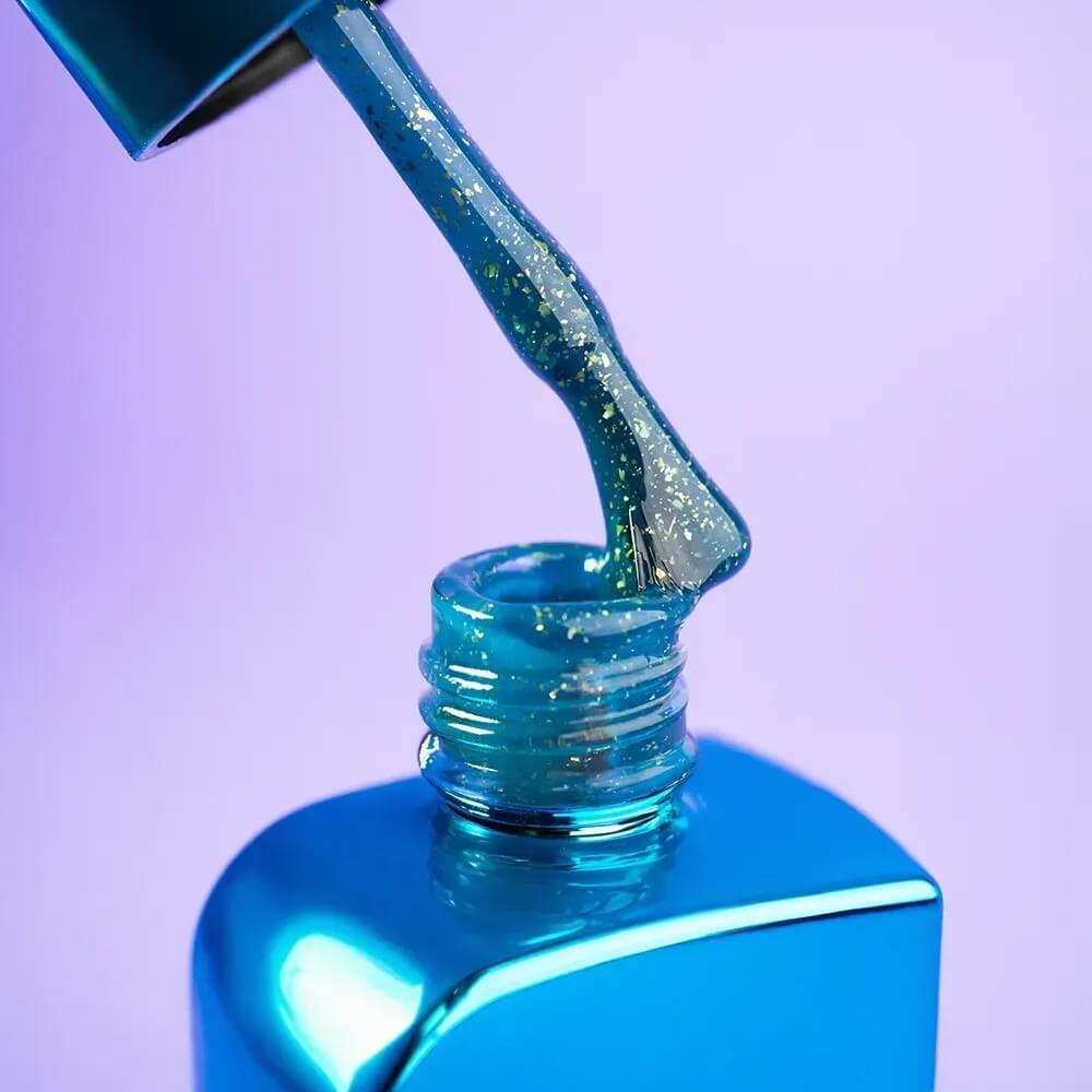 A full set of nails styled with 12ml Aquamarine in blue-green with gold accents, hand resting on a neutral surface