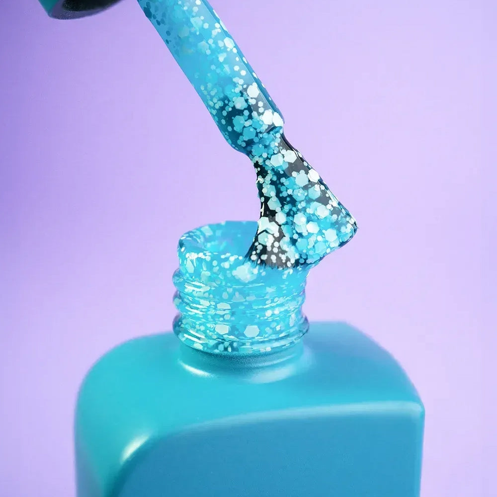 A full set of nails styled with 12ml Breeze in fluorescent blue, hand resting on a neutral surface