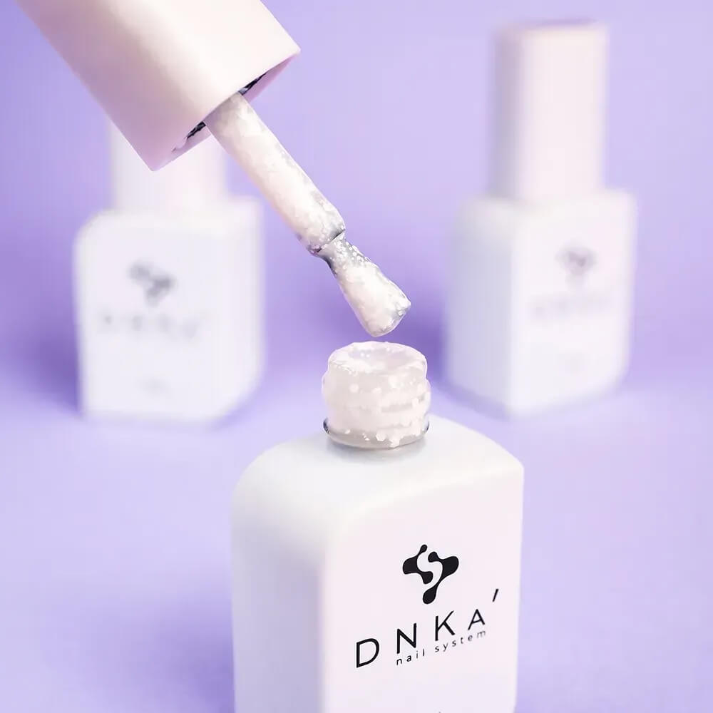 Nails freshly cured in 12ml Lotus, white base with visible colored polygon texture catching the light