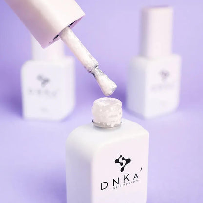 Nails freshly cured in 12ml Lotus, white base with visible colored polygon texture catching the light