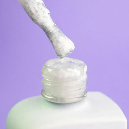 30ml bottle of Lotus (white with polygon flecks) next to a DNKa top coat bottle, ready to seal