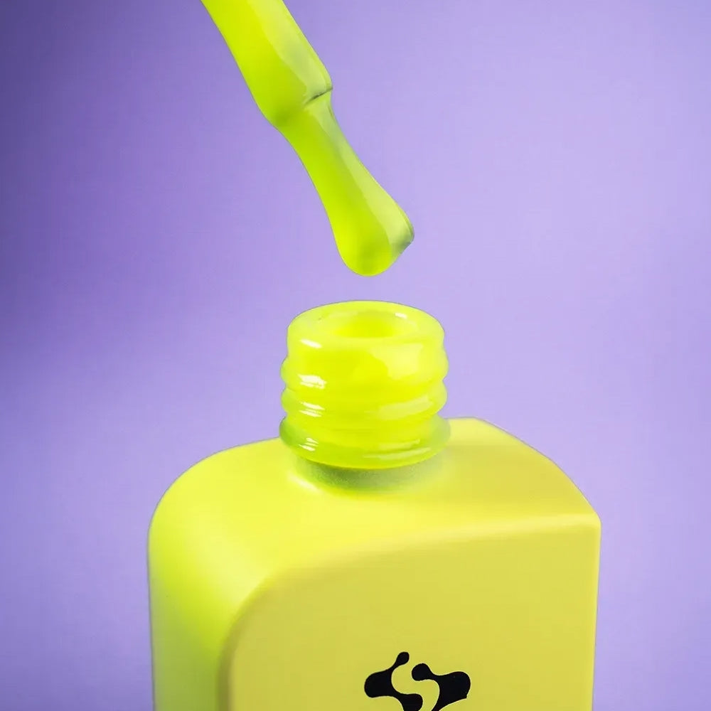 12ml bottle of Crash in neon lemon yellow next to a DNKa top coat bottle