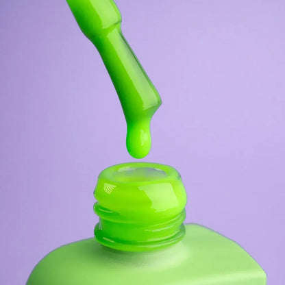 12ml bottle of Risky in pure neon green next to a DNKa top coat bottle
