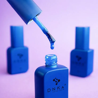 Open 12ml Azure bottle with brush against the cap, blue shimmer gel on the bristles