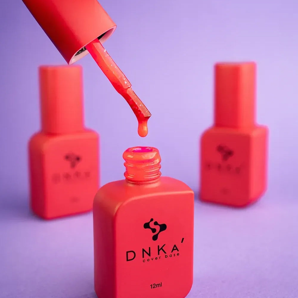 The Furor brush lifted from an open 12ml bottle, pink and gold residue coating the bristles