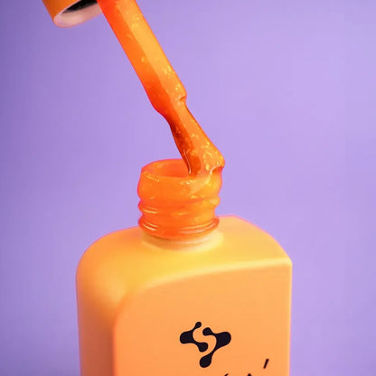 A hand with all ten nails finished in Citrus, sparkling orange coverage across the set