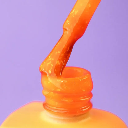 The Citrus brush lifted from an open 12ml bottle, orange glitter gel coating the bristles