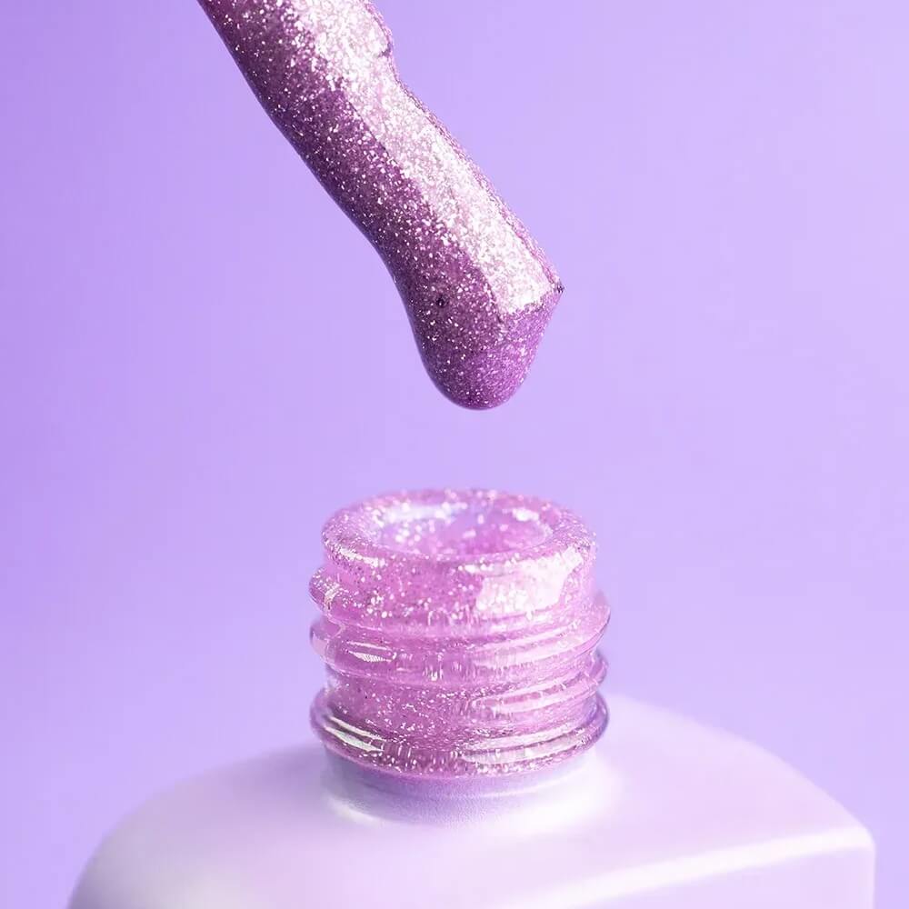 Tight crop on one finger showing Euphoria's finish — glossy, deep purple, glitter barely visible until it catches light