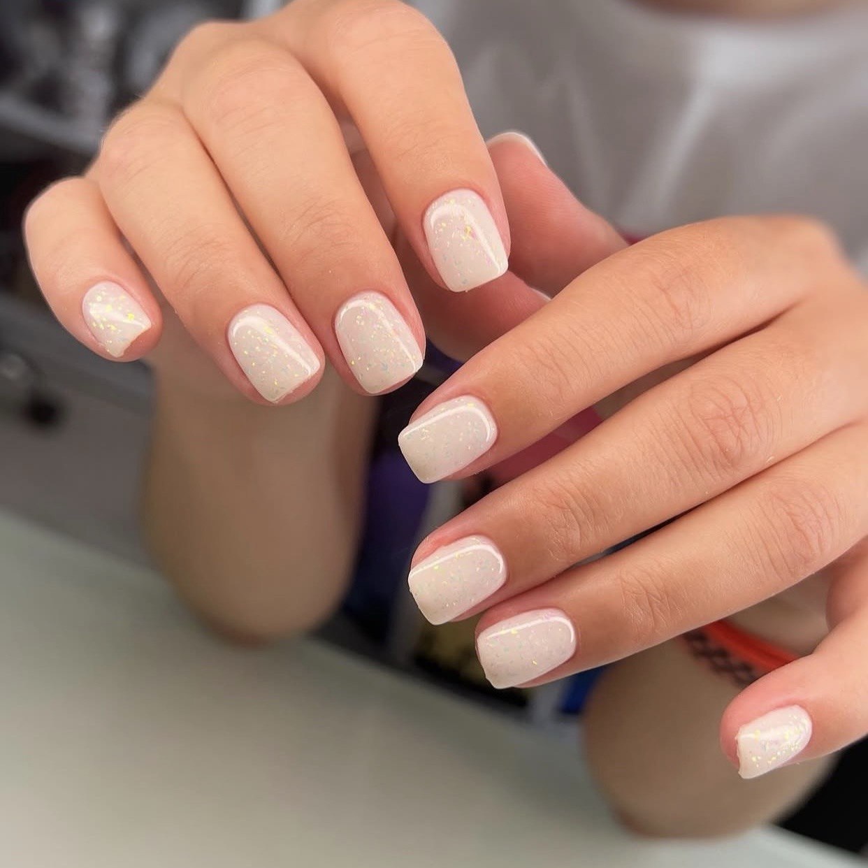 DNKa Cover Base #0095 Cocktail — open bottle with brush, milky gel with leaf flecks