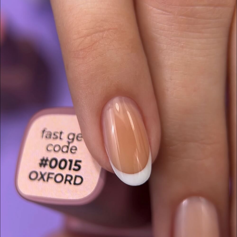 DNKa Fast Gel #0015 Oxford — swatch on nail tip, soft peach finish