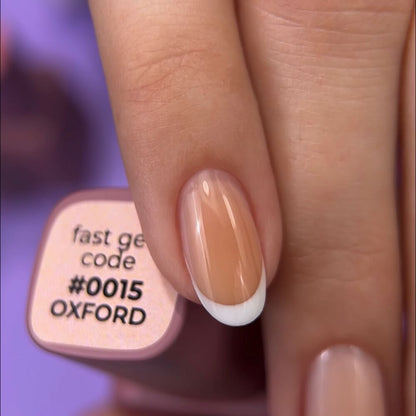 DNKa Fast Gel #0015 Oxford — swatch on nail tip, soft peach finish