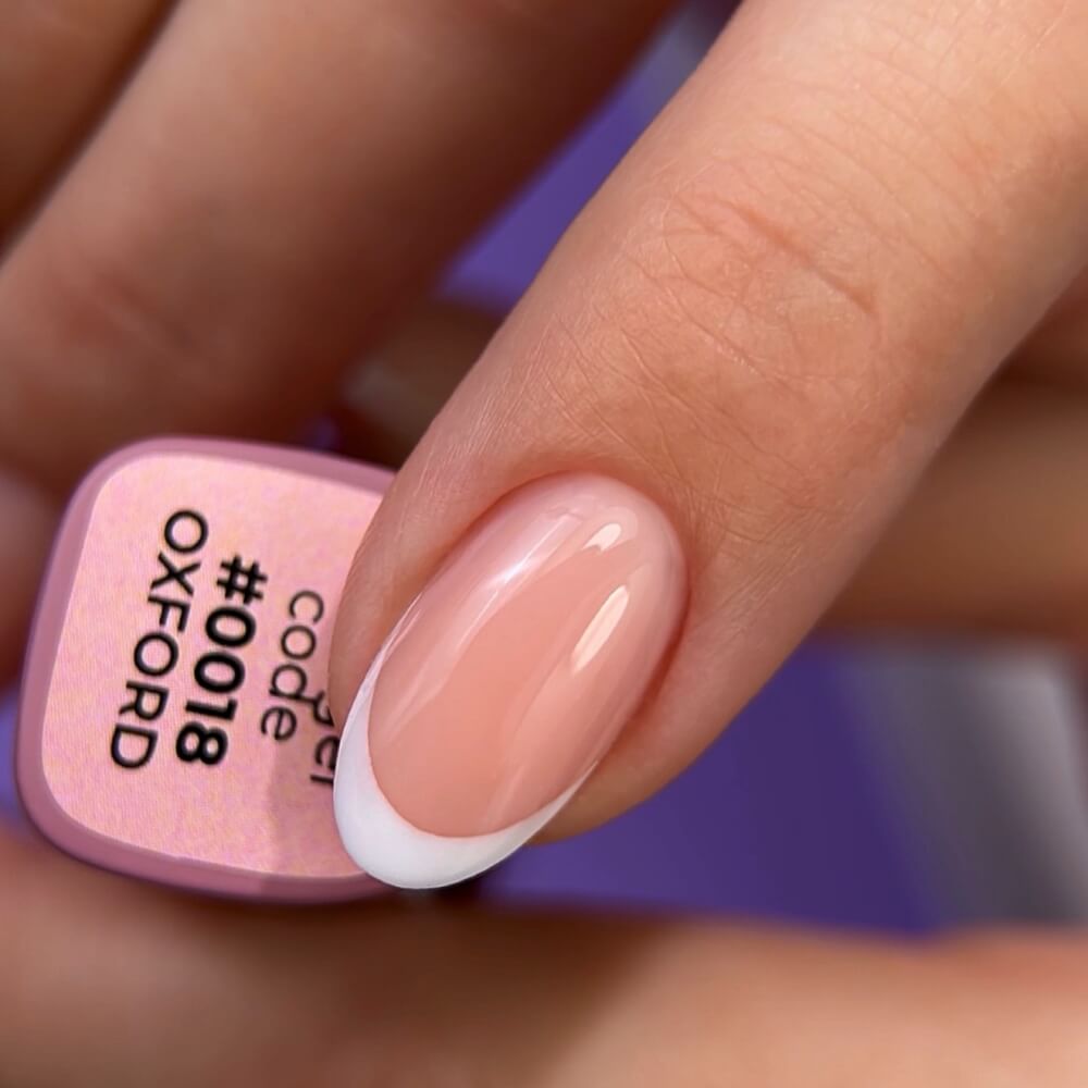 DNKa Fast Gel #0018 Oxford — swatch on nail tip, soft milky pink finish