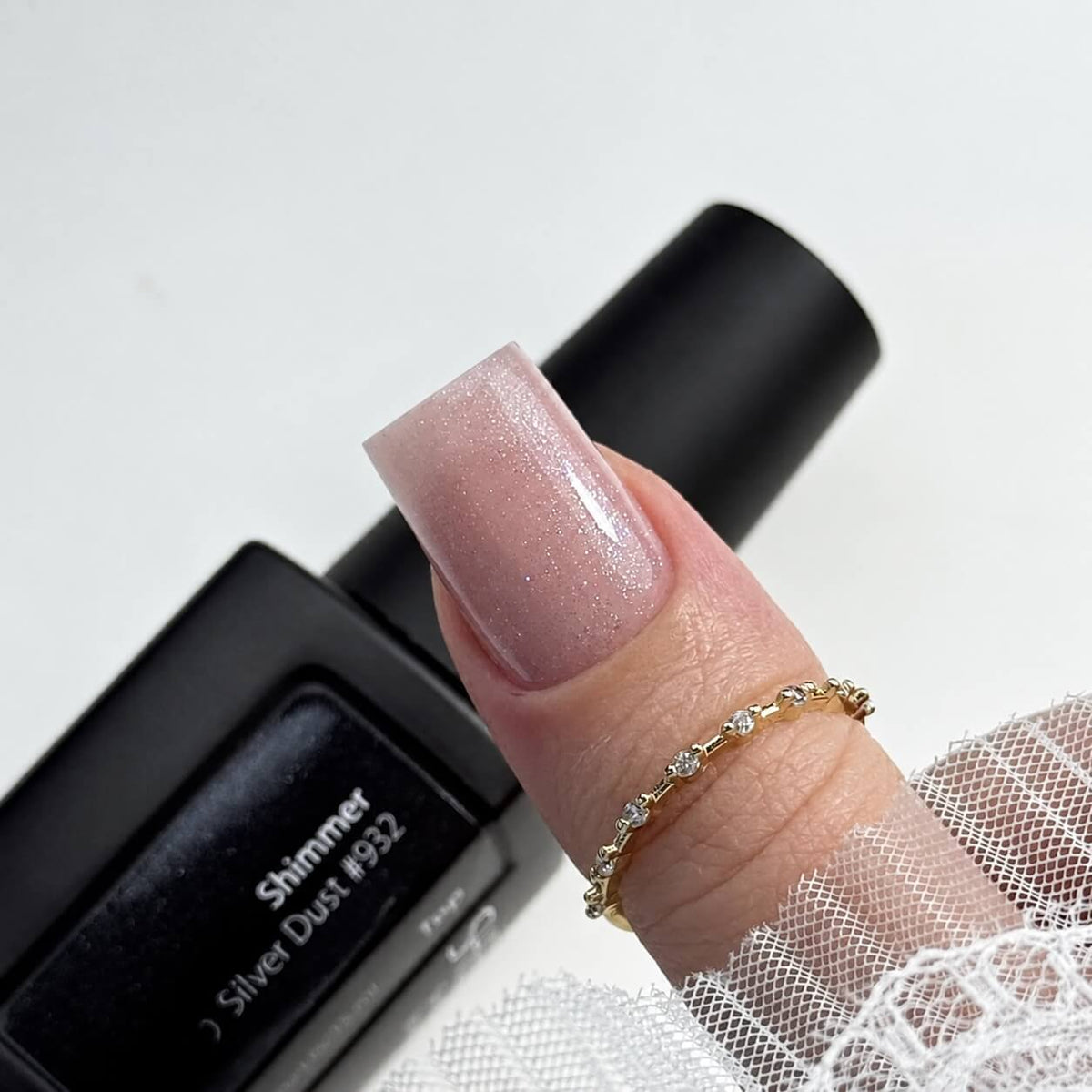 Silver Dust #932 shimmer top coat in a 0.5 fl oz bottle