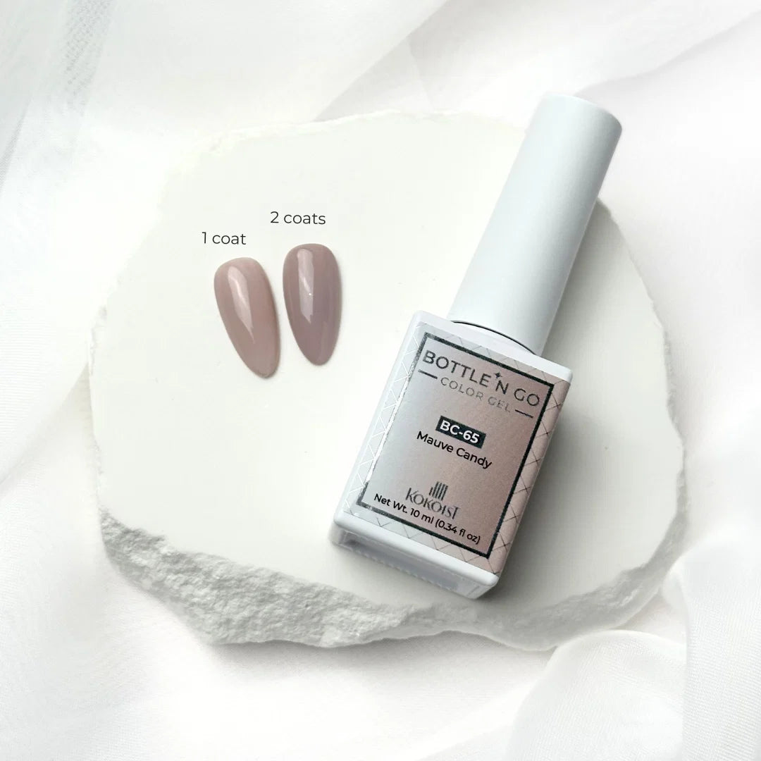 10ml — Kokoist Bottle 'N Go BC-65 Mauve Candy — swatch on nail tip, translucent mauve finish