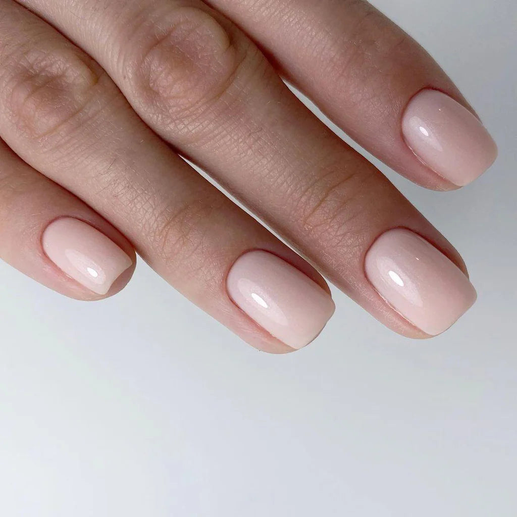 Luxio Incite Gel Polish — swatch on nail tip, pink with gold shimmer finish