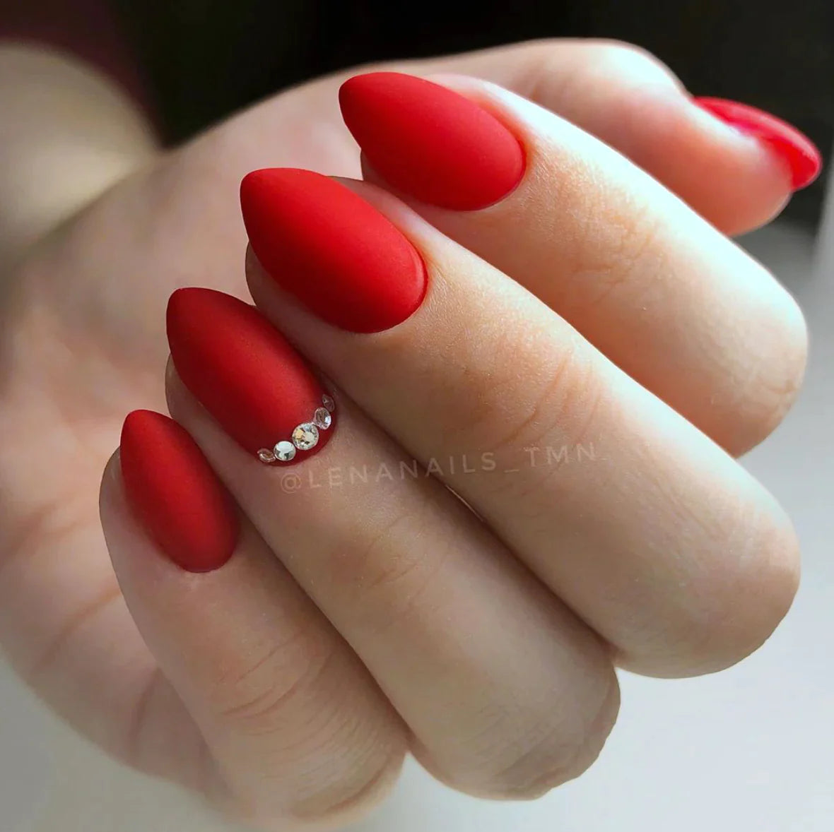 Luxio Prerogative Gel Polish — swatch on nail tip, vivid red finish