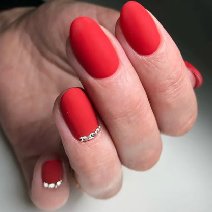 Luxio Vintage Gel Polish — swatch on nail tip, true red finish