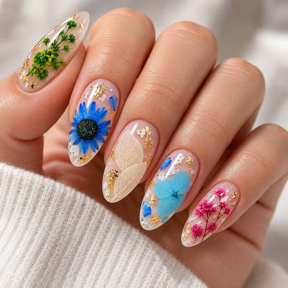 Pink nail with white and red dried flowers set under gel