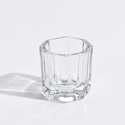 Transparent round nail crystal cup on a manicure table