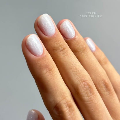 TOUCH Builder Gel Shine Bright 2 — swatch on nail tip, pale blue pearly finish