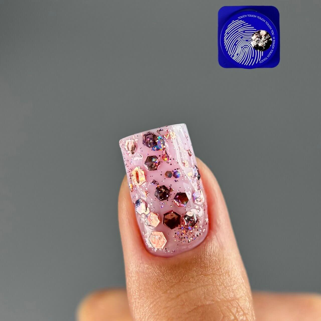 TOUCH Glow Gel 5 — swatch on nail tip, warm metallic holographic shimmer