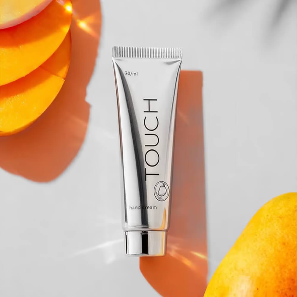 TOUCH Silver Line Hand Cream Mango — being applied to hands