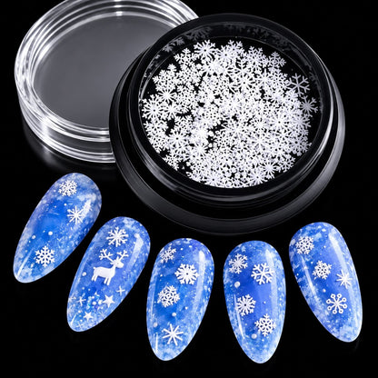 White dimensional snowflake nail embellishments in multiple sizes for festive manicures
