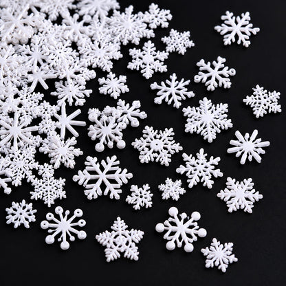 White snowflake nail decorations featuring intricate openwork designs for winter manicures